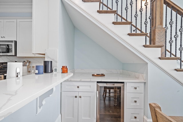 112-UNIT309 Indian Summer Path, Eatonton, GA 31024 - kitchen with beverage cooler, stainless steel microwave, white cabinets, and black stove