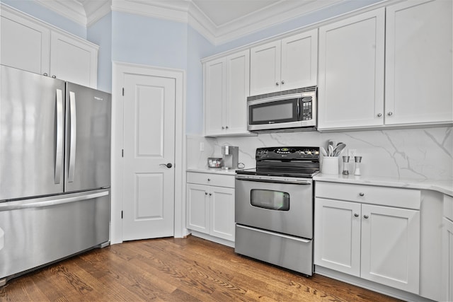 112-UNIT309 Indian Summer Path, Eatonton, GA 31024 - kitchen featuring stainless steel appliances, crown molding, white cabinetry, dark wood-style floors, and backsplash