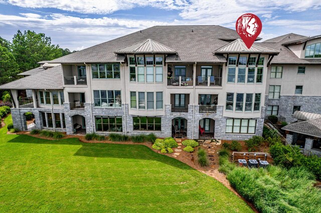 112-UNIT309 Indian Summer Path, Eatonton, GA 31024 - view of front of property featuring a standing seam roof, a front yard, stone siding, and stucco siding