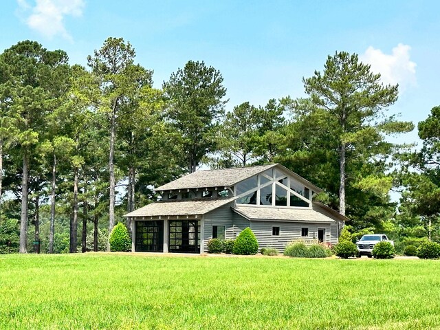 112-UNIT309 Indian Summer Path, Eatonton, GA 31024 - view of front facade featuring a front yard, a garage, and roof with shingles