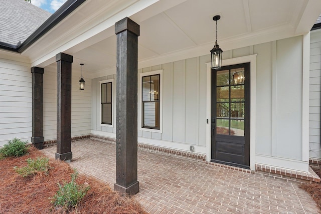 view of exterior entry featuring covered porch