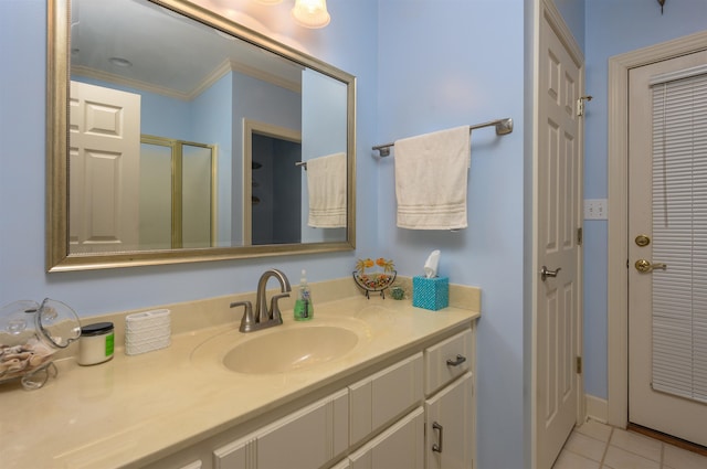 bathroom with tile patterned floors, a shower stall, vanity, and ornamental molding