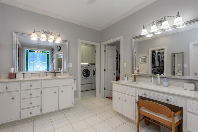 bathroom featuring vanity, a walk in closet, crown molding, washing machine and dryer, and tile patterned floors