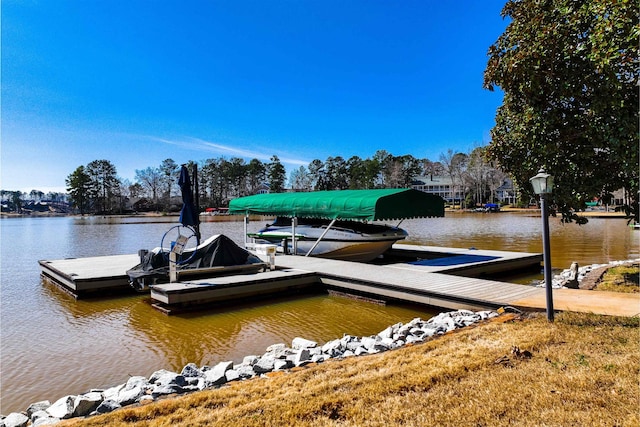 dock area with boat lift and a water view