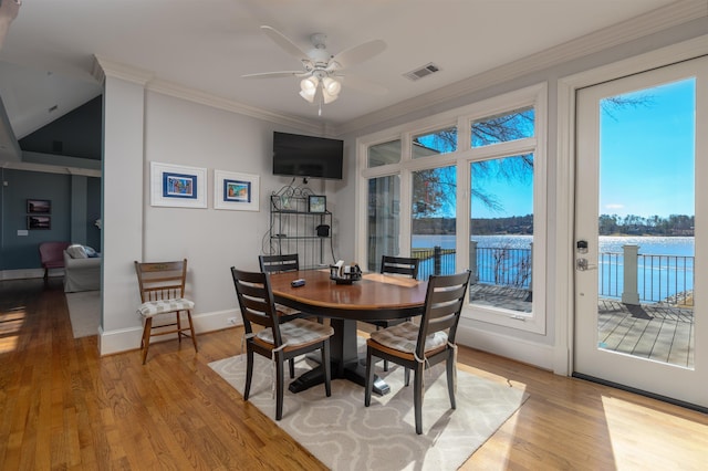 dining area with visible vents, wood finished floors, baseboards, and ornamental molding