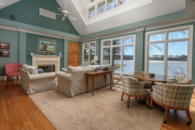 140 Winnstead Pl, Eatonton, GA 31024 - living room featuring ceiling fan, a glass covered fireplace, plenty of natural light, high vaulted ceiling, and wood finished floors