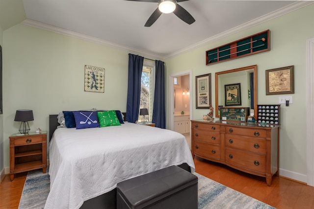 bedroom with a ceiling fan, crown molding, wood finished floors, and baseboards