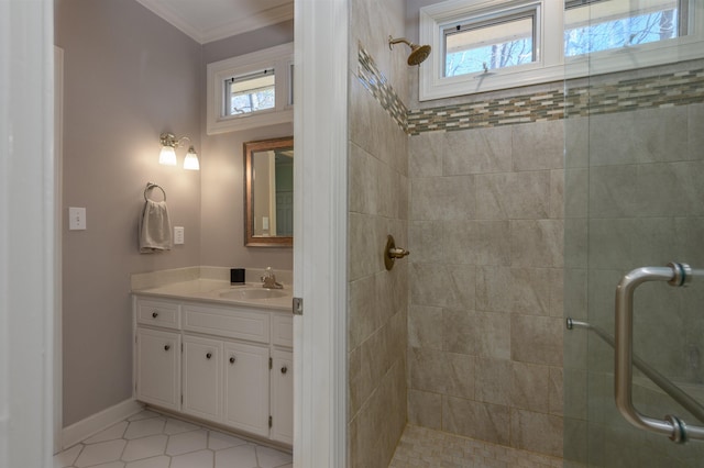 bathroom featuring a wealth of natural light, a shower stall, vanity, and crown molding