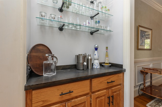 bar featuring wood finished floors and a dry bar