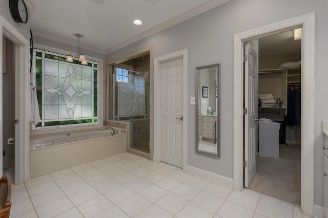 bathroom featuring tile patterned flooring, a shower stall, crown molding, a walk in closet, and a bath