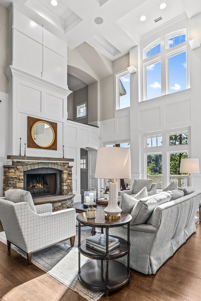 1140 Plantation Point Dr, Greensboro, GA 30642 - living area with crown molding, coffered ceiling, a stone fireplace, and dark wood-type flooring