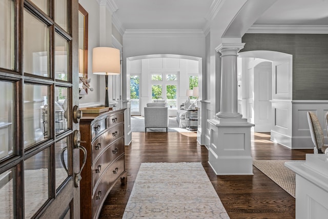 1140 Plantation Point Dr, Greensboro, GA 30642 - entrance foyer featuring crown molding, decorative columns, a wainscoted wall, arched walkways, and dark wood finished floors