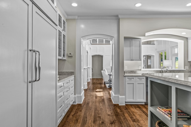 1140 Plantation Point Dr, Greensboro, GA 30642 - kitchen featuring crown molding, arched walkways, recessed lighting, dark wood-style floors, and glass insert cabinets