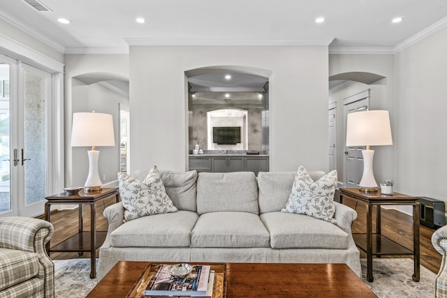 1140 Plantation Point Dr, Greensboro, GA 30642 - living room featuring arched walkways, recessed lighting, ornamental molding, and wood finished floors