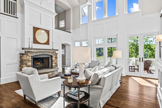 1140 Plantation Point Dr, Greensboro, GA 30642 - living room with a fireplace, a decorative wall, dark wood finished floors, and a towering ceiling