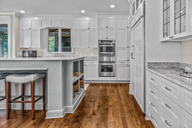 1140 Plantation Point Dr, Greensboro, GA 30642 - kitchen with glass insert cabinets, a warming drawer, white cabinets, and dark wood-style floors