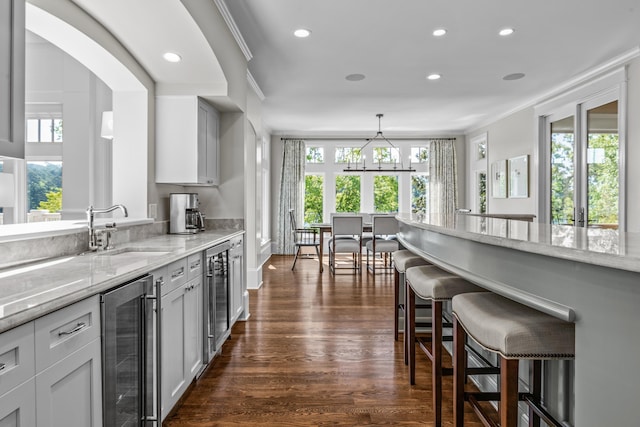 1140 Plantation Point Dr, Greensboro, GA 30642 - kitchen with wine cooler, plenty of natural light, a breakfast bar, and a sink