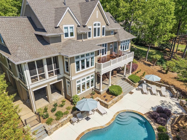 1140 Plantation Point Dr, Greensboro, GA 30642 - back of house with a shingled roof, an outdoor pool, a patio area, and a wooden deck