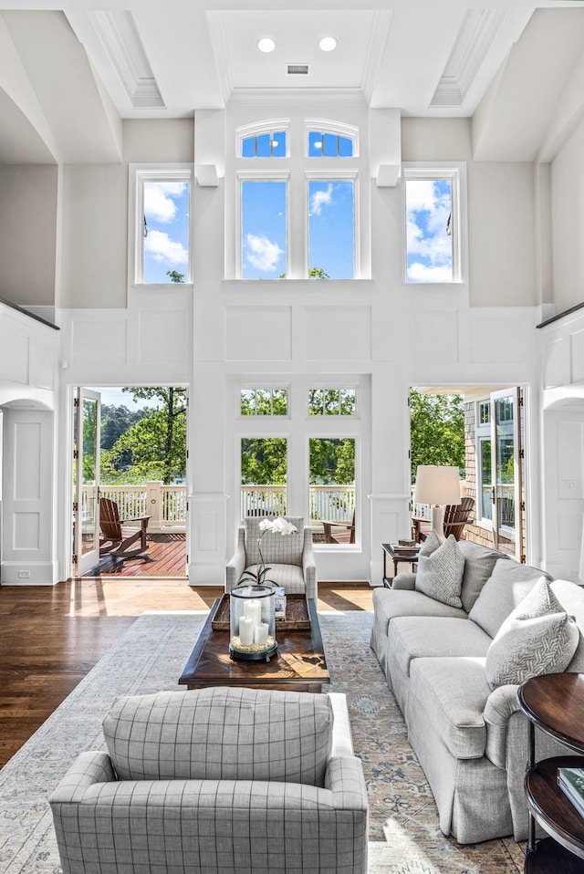 1140 Plantation Point Dr, Greensboro, GA 30642 - living room featuring crown molding, a high ceiling, plenty of natural light, and a decorative wall