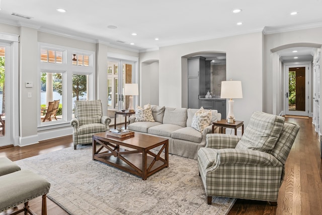 1140 Plantation Point Dr, Greensboro, GA 30642 - living room featuring visible vents, crown molding, wood finished floors, recessed lighting, and arched walkways