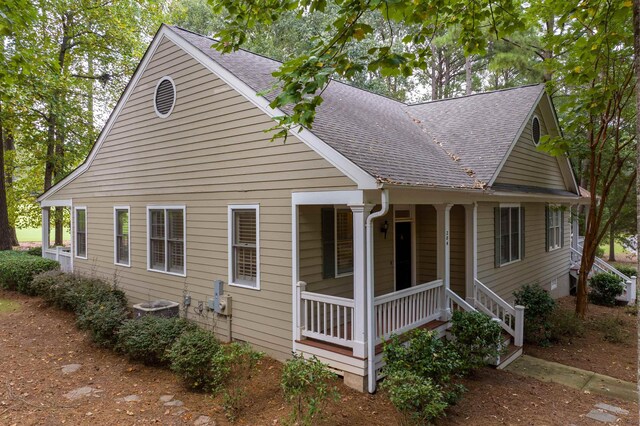 view of front of house with a porch and central AC unit