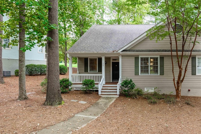 bungalow-style home featuring a porch and cooling unit