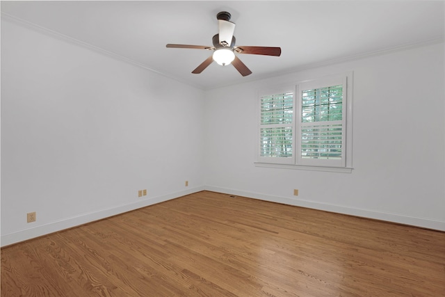 empty room featuring crown molding, ceiling fan, and light wood-type flooring