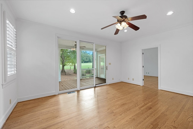 empty room with crown molding, light hardwood / wood-style floors, and ceiling fan