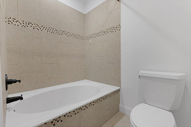 bathroom featuring tiled shower / bath and toilet