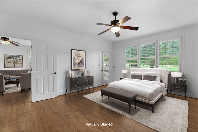 bedroom featuring dark hardwood / wood-style flooring, access to outside, ornamental molding, and ceiling fan