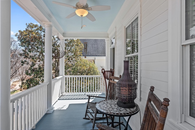 wooden deck with a ceiling fan and covered porch