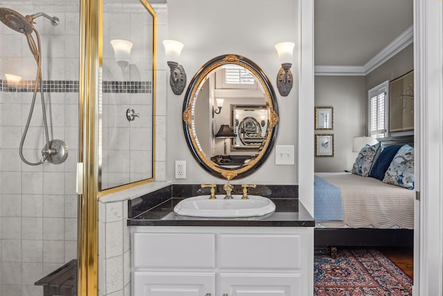 bathroom with ornamental molding, tiled shower, vanity, and ensuite bathroom