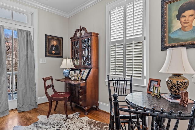 office space featuring ornamental molding, baseboards, and wood finished floors