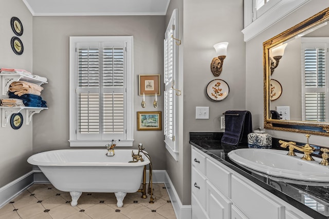 bathroom featuring ornamental molding, tile patterned flooring, a freestanding tub, and vanity