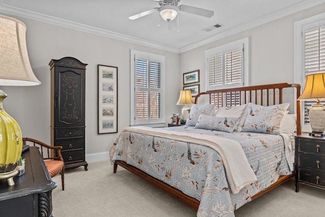 carpeted bedroom featuring ceiling fan, ornamental molding, visible vents, and baseboards