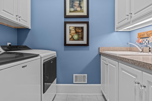 washroom featuring cabinet space, visible vents, washer and clothes dryer, tile patterned flooring, and a sink