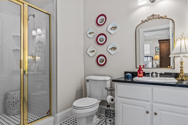 full bathroom featuring toilet, a stall shower, baseboards, and vanity