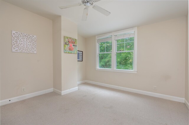 empty room with vaulted ceiling, light carpet, and ceiling fan