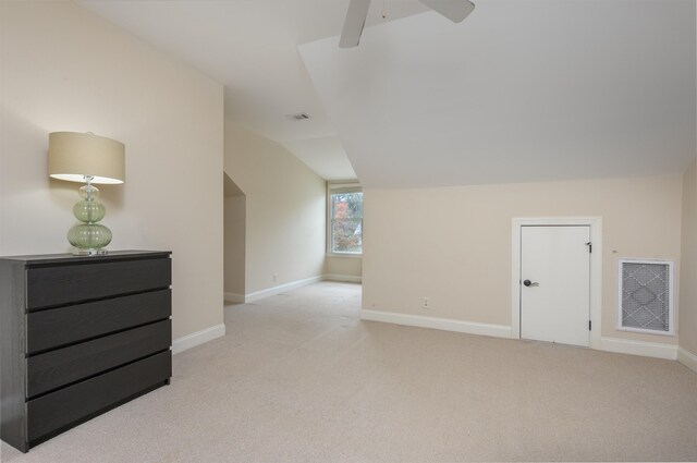 additional living space with lofted ceiling, light colored carpet, and ceiling fan