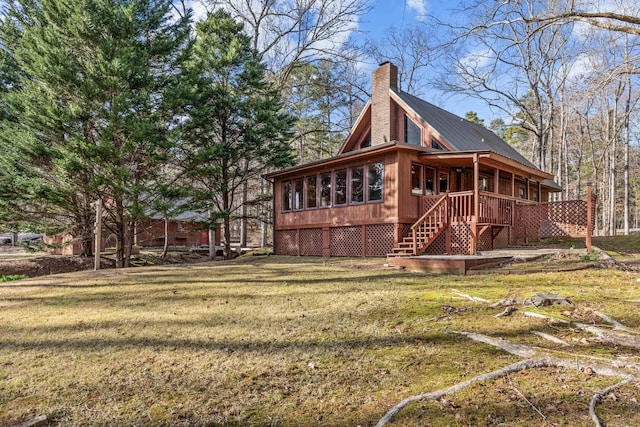 view of home's exterior featuring stairs, a yard, and a chimney