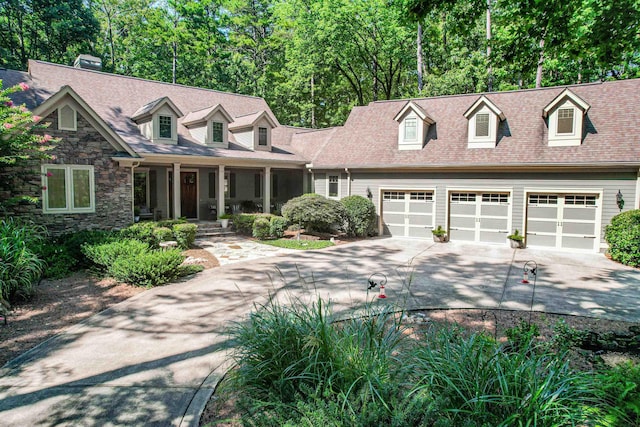 cape cod-style house with a garage and covered porch