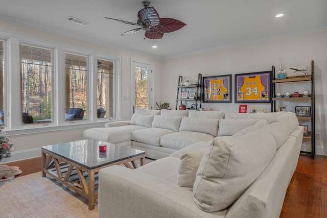living room with crown molding, ceiling fan, hardwood / wood-style flooring, and a wealth of natural light