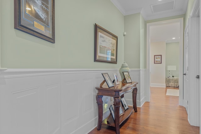 hallway featuring hardwood / wood-style flooring and crown molding