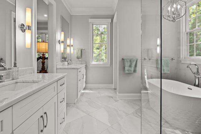 bathroom featuring a healthy amount of sunlight, ornamental molding, a bath, and vanity