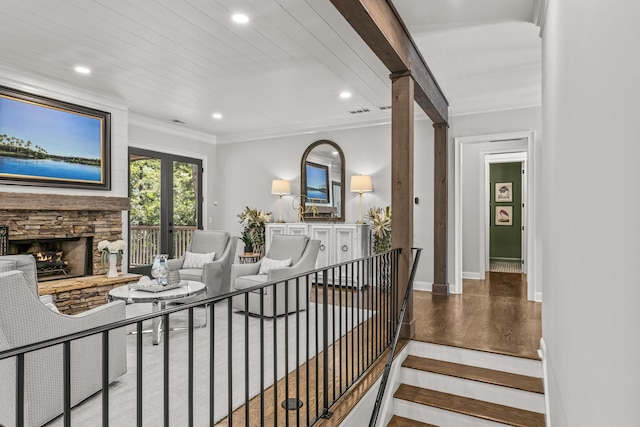 interior space with crown molding, a fireplace, and hardwood / wood-style floors