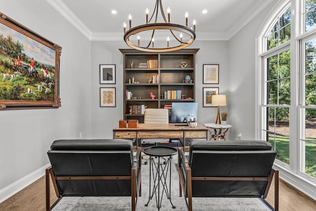 home office with ornamental molding, a wealth of natural light, hardwood / wood-style floors, and a chandelier