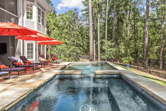 view of pool with an in ground hot tub and a patio area