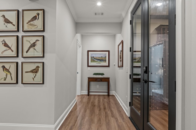 hall with crown molding and hardwood / wood-style floors