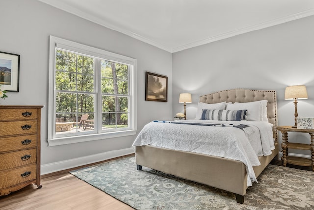 bedroom with hardwood / wood-style flooring and crown molding