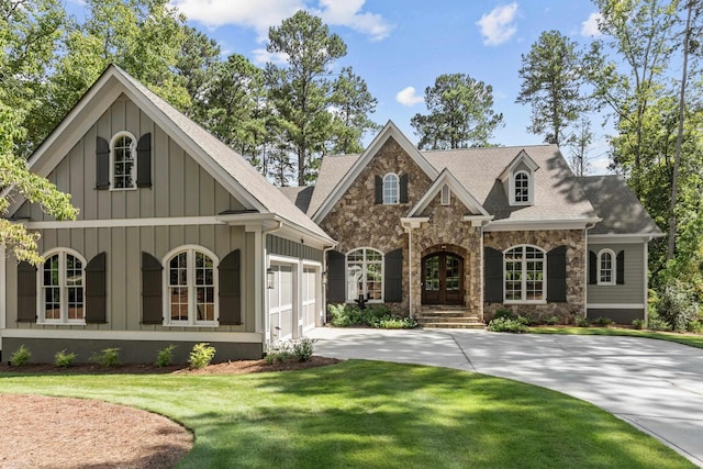 view of front of house featuring french doors, a garage, and a front yard